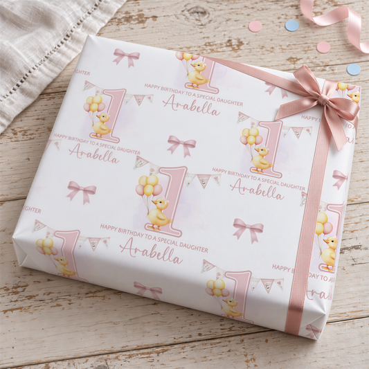 A gift box with a pink ribbon and a repeating pattern of a yellow duck holding balloons, along with the text "Happy Birthday to a Special Daughter" and "A. abella".