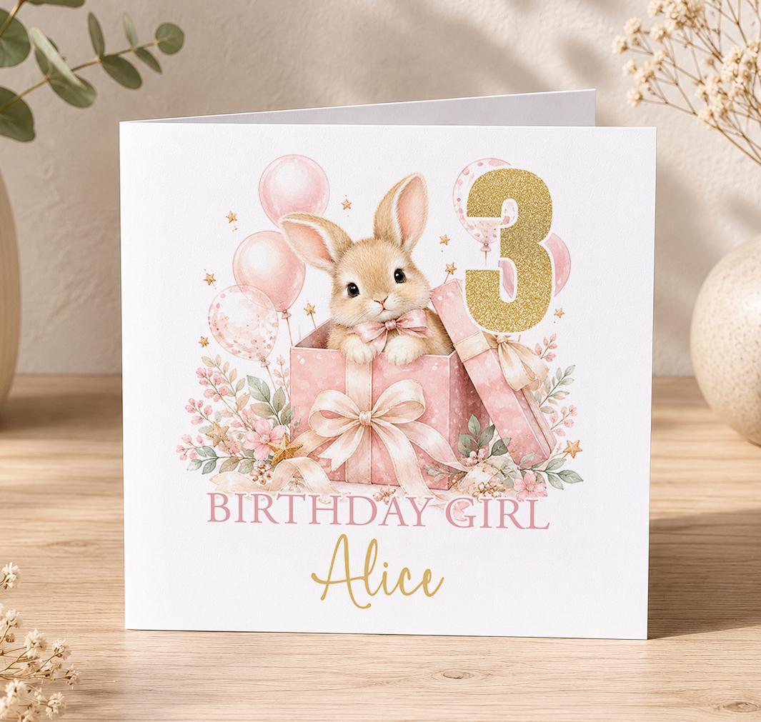 Personalised pink bunny birthday card – bunny in a pink present with balloons and a gold 3, Birthday Girl Alice
