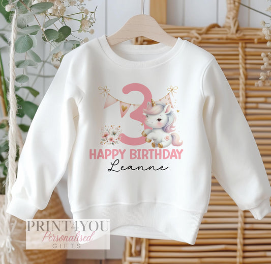 Personalised white cotton sweatshirt for children with pink party unicorn design, customised with name and birthday age