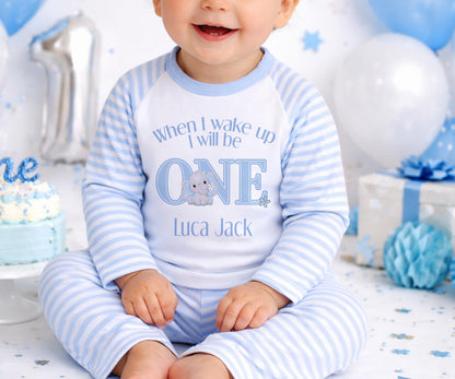 Personalised first birthday pyjamas with blue elephant design and custom name, soft cotton.
