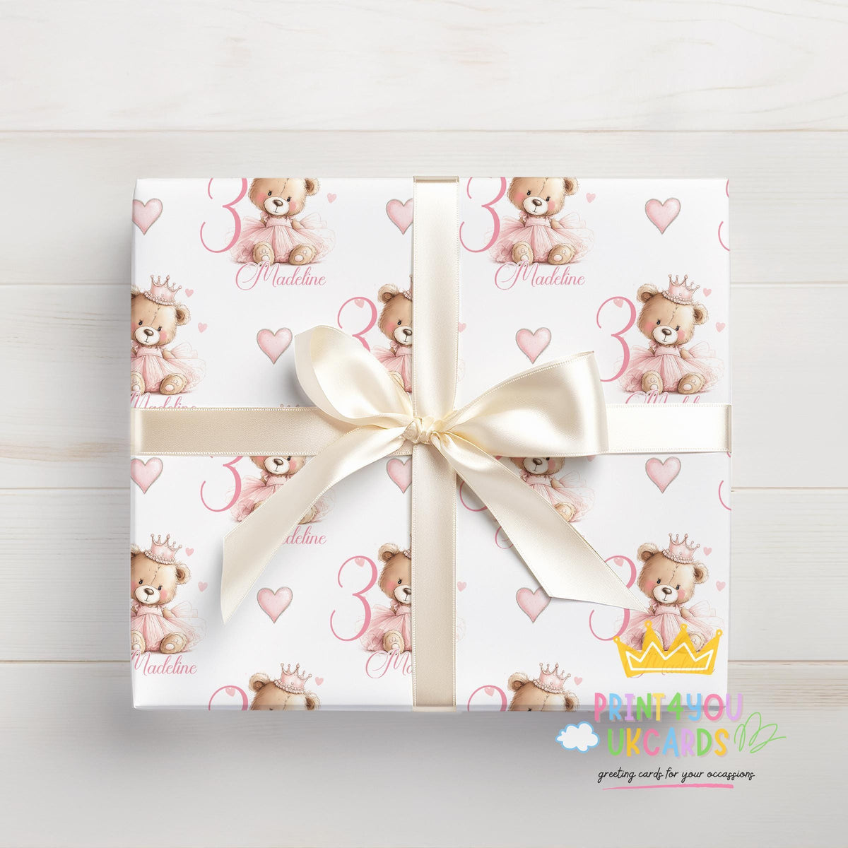 Gift wrapped in the personalised pink princess teddy bear wrapping paper, tied with ribbon.