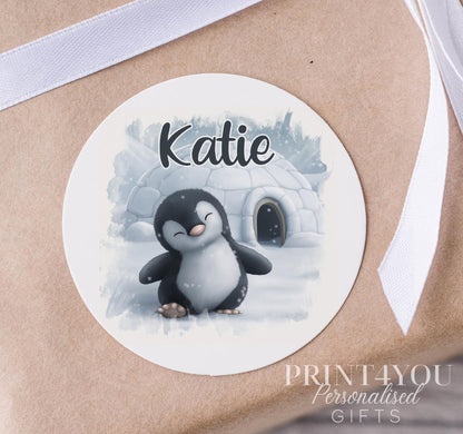 Personalised Christmas penguin sticker with a custom name, glossy white 5cm round strip label