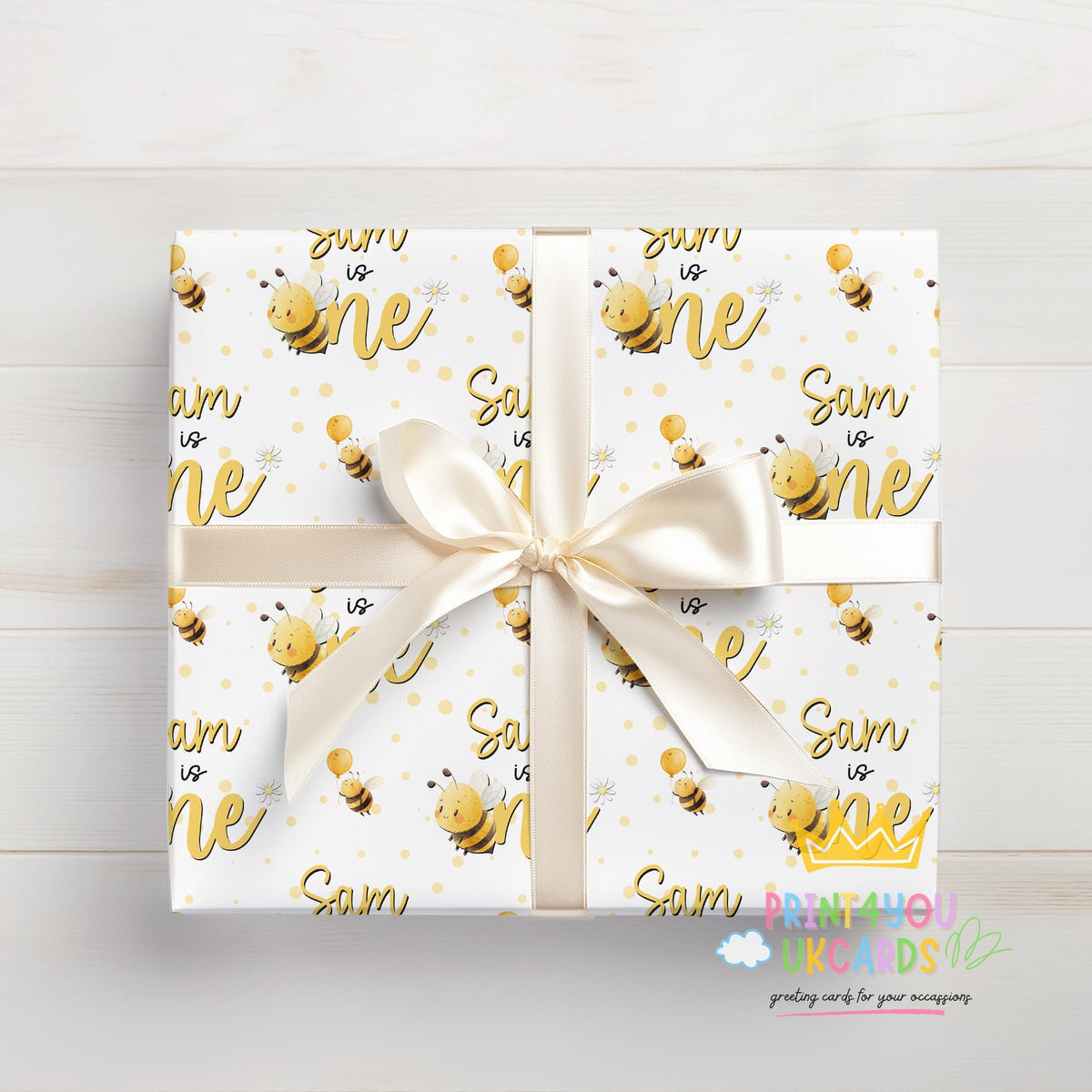 Personalised bee birthday wrapping paper sheet laid flat showing the full pattern