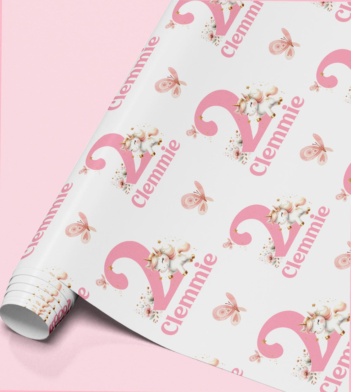 Pink and white unicorn wrapping paper personalised with the name 'Clennie', repeated across the pattern with butterflies