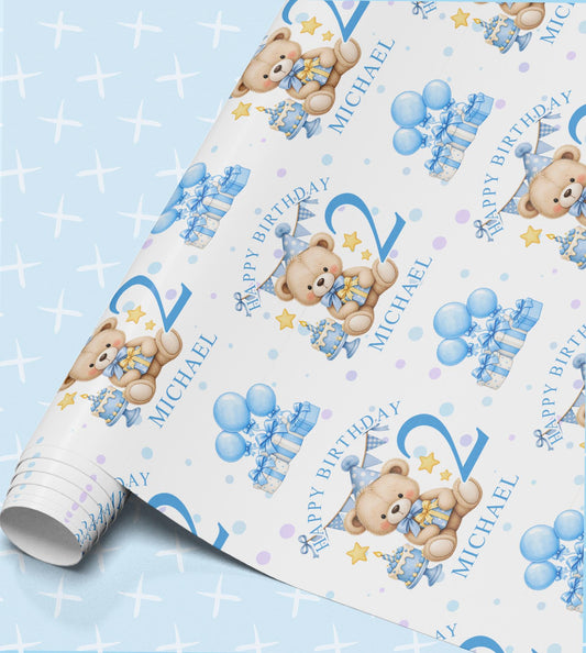 Personalised birthday wrapping paper with teddy bears in blue party hats, balloons and gift boxes, printed with Happy Birthday, the age 2 and the name Michael on a pale blue sparkle background