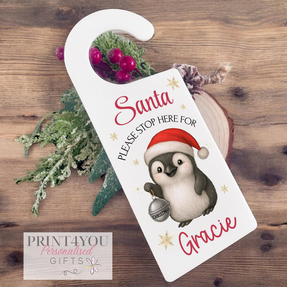 Personalised Santa Stop Here acrylic door hanger with a custom name printed on white acrylic, ready to hang on a bedroom door for Christmas Eve