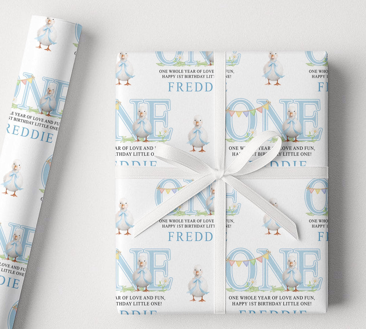 Personalised blue duck first birthday wrapping paper with custom name, pastel blue design and duck illustrations.