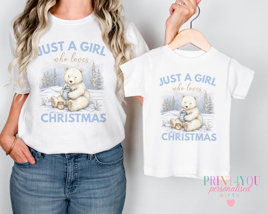 Mother and daughter wearing matching "Just a Girl Who Loves Christmas" t-shirts with a polar bear design