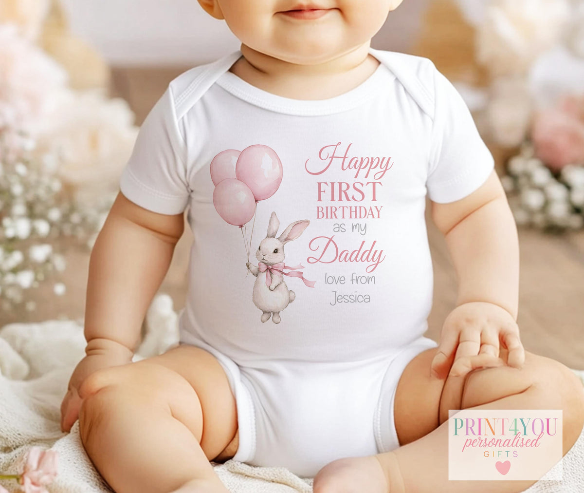 Personalised pink bunny 1st birthday sleepsuit, soft breathable cotton printed with a chosen name and relation.