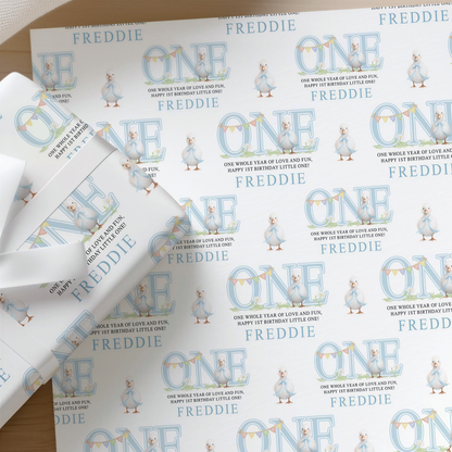 Roll of personalised blue duck 1st birthday wrapping paper printed with a name