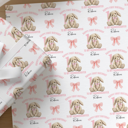 Repeating pattern of a pink baby rabbit design on personalised wrapping paper for a girl's 1st birthday