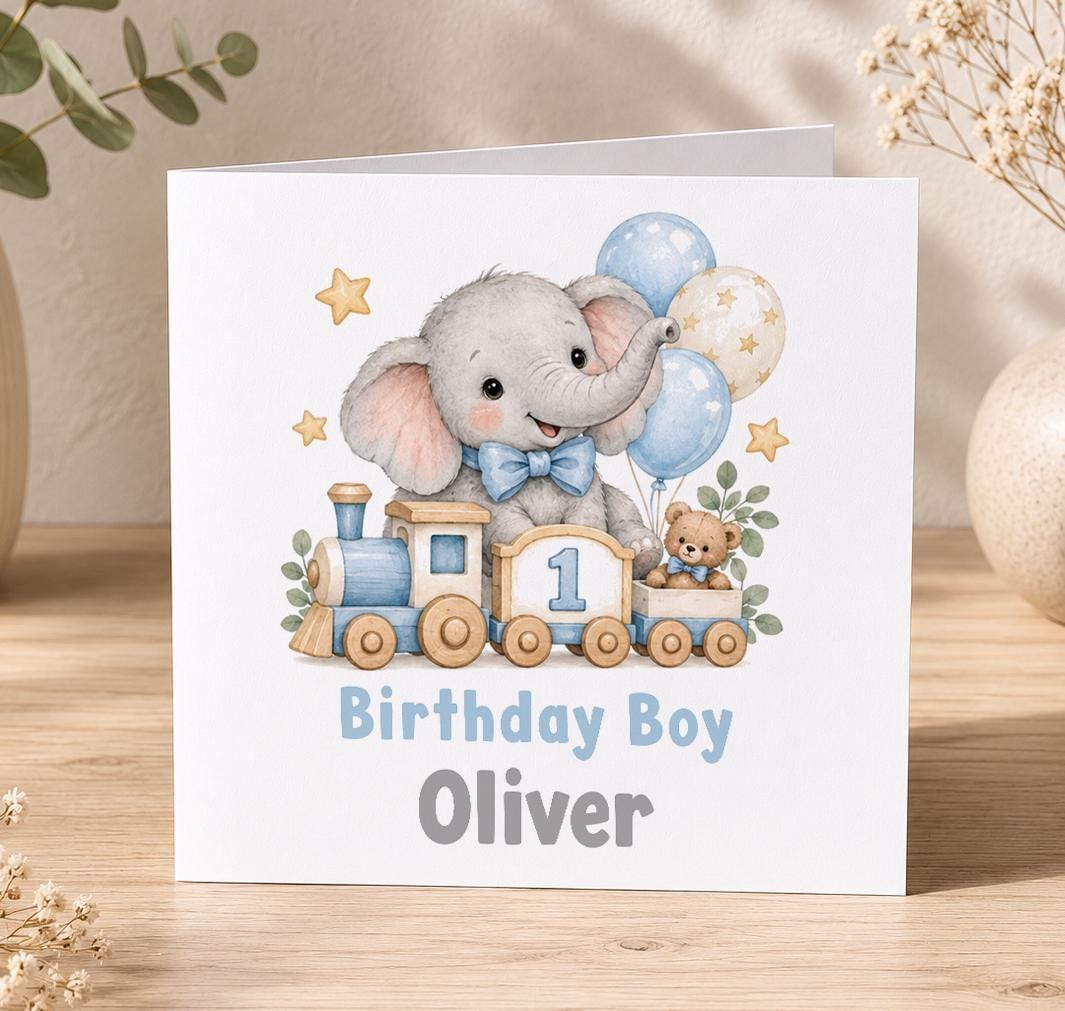 Personalised elephant train 1st birthday card – grey elephant on a toy train with a number 1, blue balloons and Birthday Boy Oliver