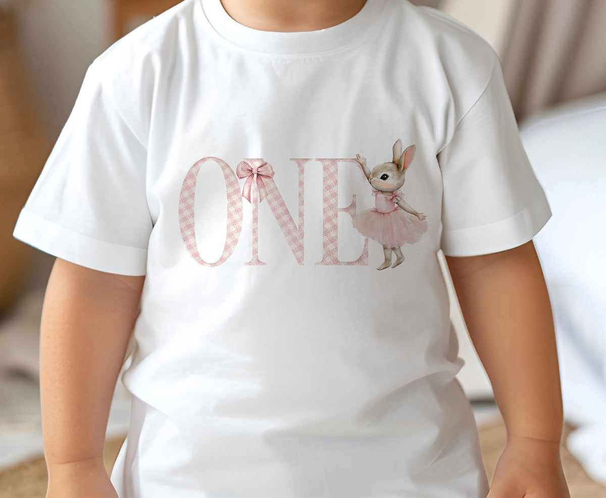 Baby wearing a soft white cotton first birthday t-shirt with an age number, size 6-12 months