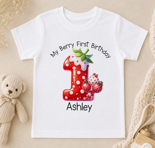 White t-shirt printed with a red number 1, strawberries and the text 'My Berry First Birthday Ashley'.