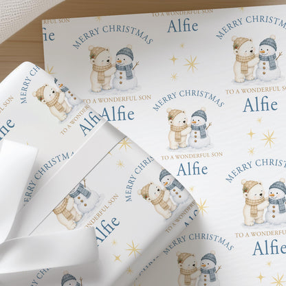 Personalised polar bear and snowman Christmas wrapping paper with a custom name printed into the repeating festive pattern