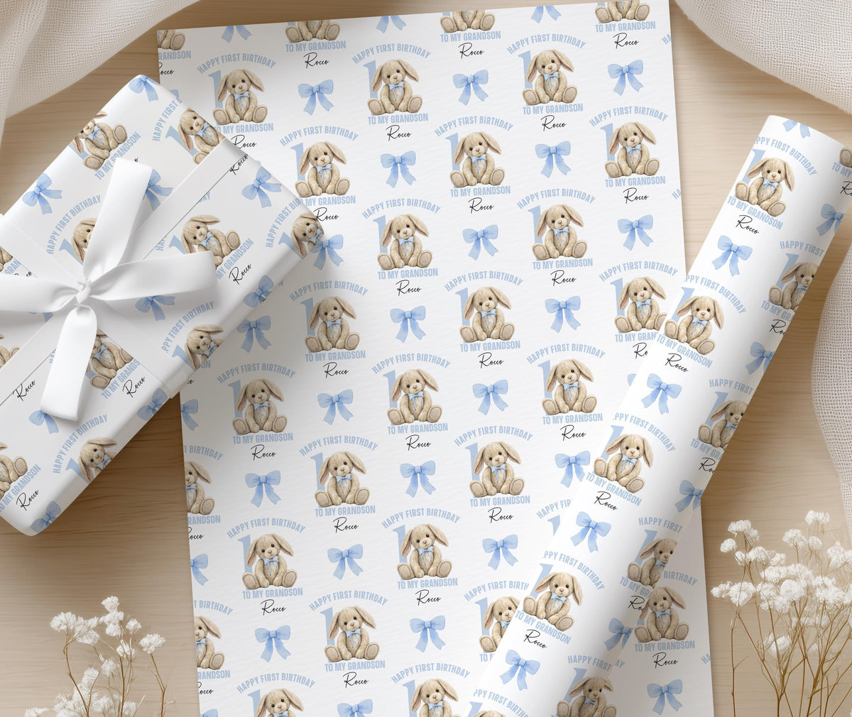 Roll of personalised pastel blue bunny wrapping paper shown in full pattern repeat.