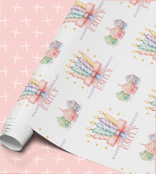 Personalised birthday wrapping paper roll with pastel striped candles tied with pink bows, cupcakes, gold stars and the name Emily with Happy 4th Birthday