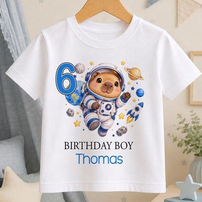 Personalised capybara astronaut birthday t-shirt – white tee with a capybara astronaut among planets, blue number 6, Birthday Boy and the name Thomas