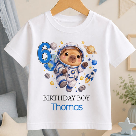 Personalised capybara astronaut birthday t-shirt – white tee with a capybara astronaut among planets, blue number 6, Birthday Boy and the name Thomas