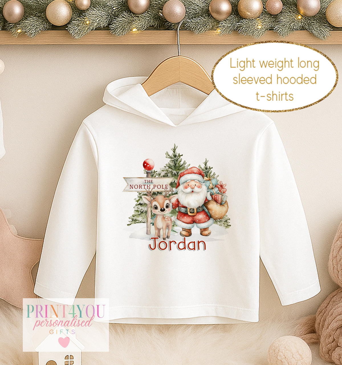 Personalised Christmas hooded t-shirt, white long sleeved hoodie printed with Santa and a reindeer at the North Pole and a name in blue