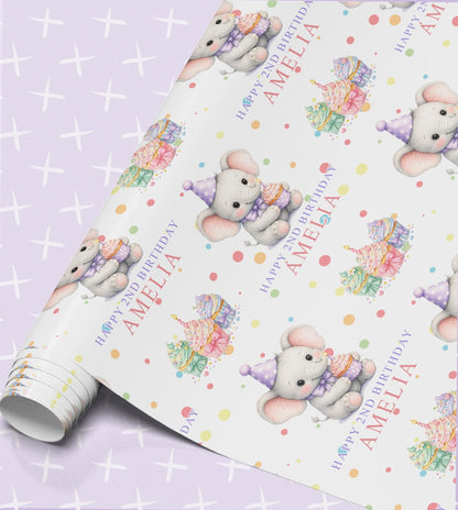 Personalised birthday wrapping paper roll with a grey elephant in a party hat, rainbow cupcakes, confetti dots and the name Amelia with Happy 2nd Birthday