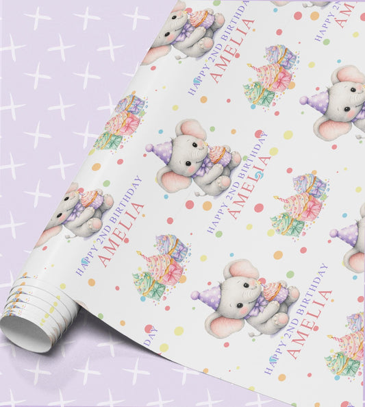 Personalised birthday wrapping paper roll with a grey elephant in a party hat, rainbow cupcakes, confetti dots and the name Amelia with Happy 2nd Birthday
