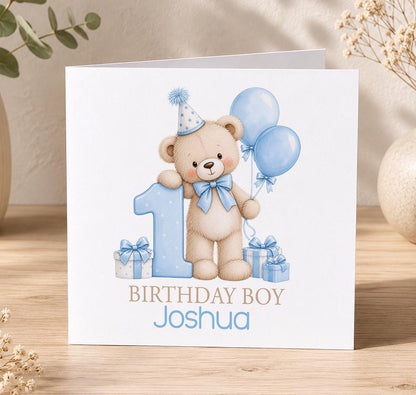 Personalised teddy bear 1st birthday card – teddy with blue balloons and a big blue number 1, Birthday Boy Joshua