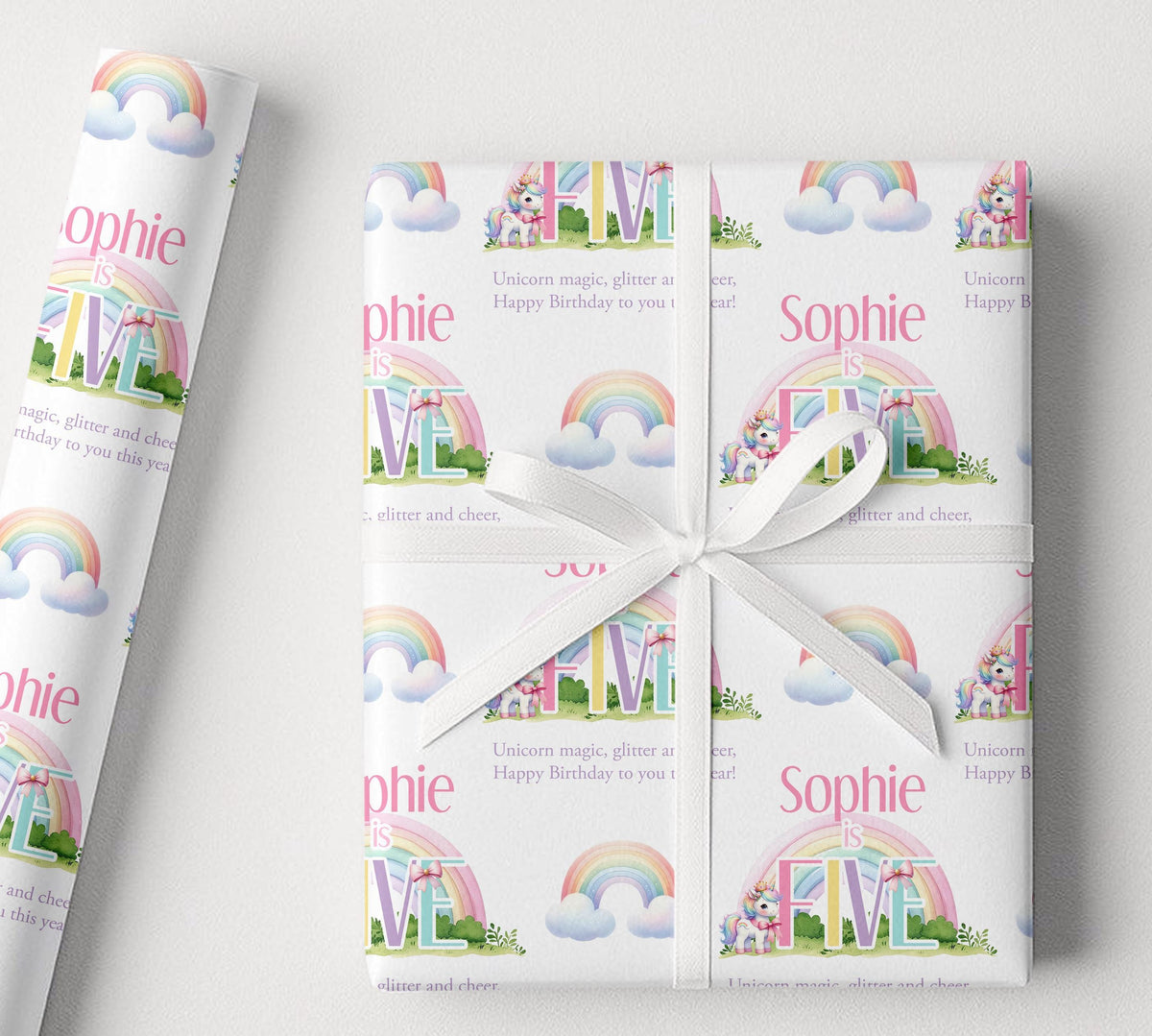 Sheet of personalised rainbow unicorn birthday wrapping paper laid flat