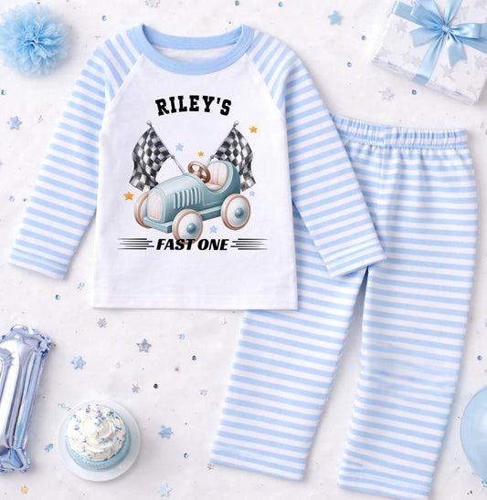 Personalised blue stripe race car pyjamas for a boy's 1st birthday with custom name