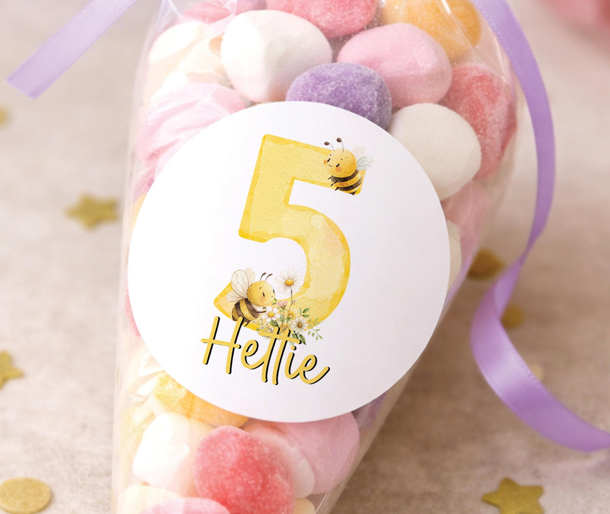 Round glossy stickers featuring a bee and floral design, personalised with a birthday child's name