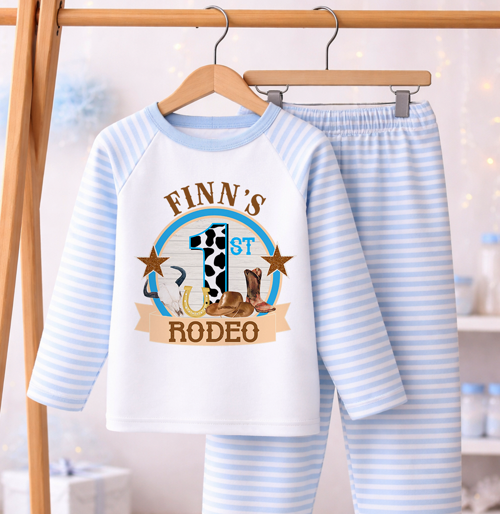 Blue and white striped pyjama set printed with a personalised name, laid flat against a white background