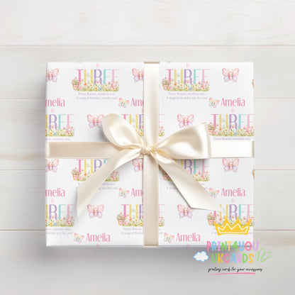 Personalised butterfly garden birthday wrapping paper wrapped around a gift