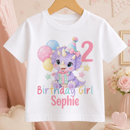 Personalised dinosaur birthday t-shirt – white tee with a lilac dinosaur in a party hat with balloons, pink number 2, Birthday Girl and the name Sophie