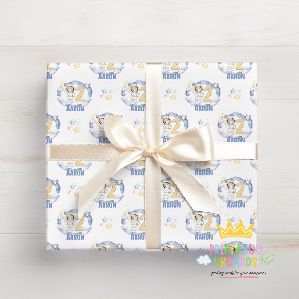 An additional close-up of the moon, stars and astronaut pattern printed on the wrapping paper