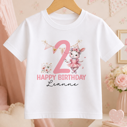 A white t-shirt with a pink bunny and the number "2" printed on it, along with the text "Happy Birthday Leanne".