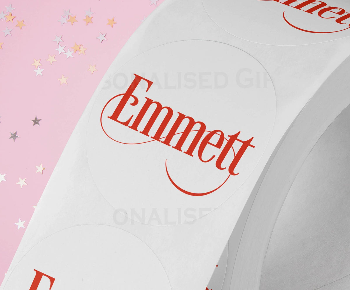 Personalised colourful festive name sticker stuck onto Christmas gift wrapping