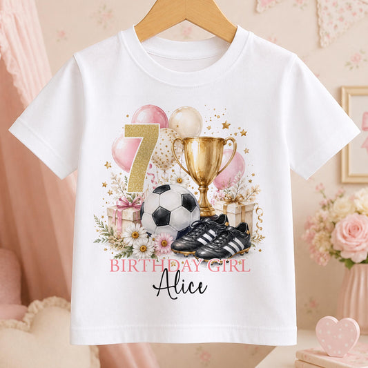 White girls football birthday t-shirt with a gold number 7, football, trophy and boots, pink balloons and daisies, and Birthday Girl above the name Alice