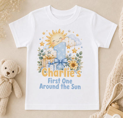 Personalised First One Around the Sun first birthday t-shirt – smiling sun, blue number 1 and the name Charlie