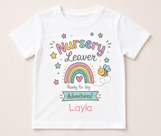 White children's T-shirt printed with a colourful rainbow and bee nursery leaver design, personalised with a child's name, front view flat lay.