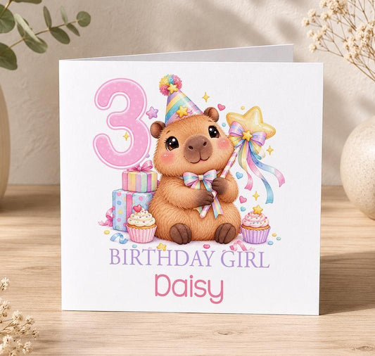 Personalised capybara birthday card – capybara in a party hat with a star wand, cupcakes and a pink 3, Birthday Girl Daisy