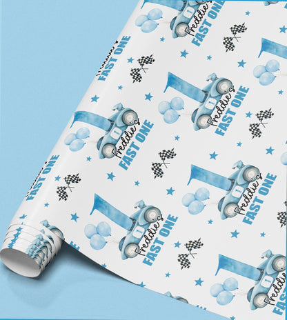 Roll of personalised wrapping paper with a repeating pattern of blue racing cars, balloons and stars