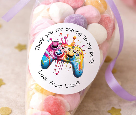 Round glossy stickers featuring a video game controller design, personalised as thank-you party labels