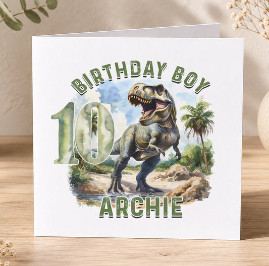 Personalised T-Rex dinosaur birthday card example showing custom name and age printed in the jungle design