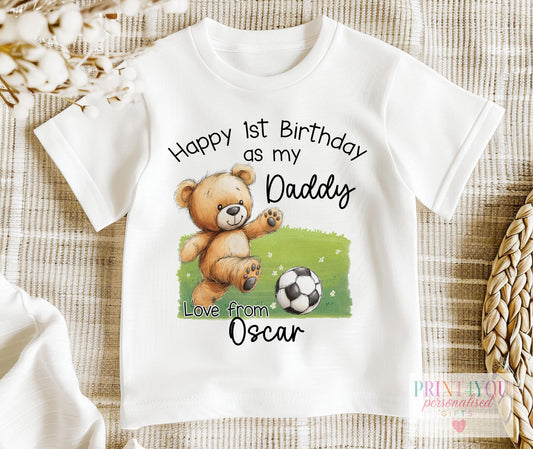 White baby bib personalised with a teddy bear football first birthday design for Daddy, with baby's name underneath