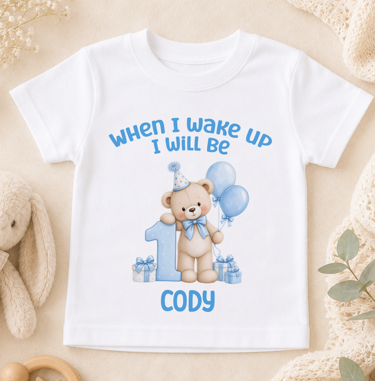 Personalised white baby t-shirt printed When I Wake Up I Will Be 1 with a blue teddy bear, balloons and the name Cody