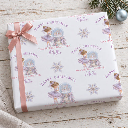 Two stacked gifts wrapped in personalised ballerina Christmas wrapping paper printed with the name Elsie