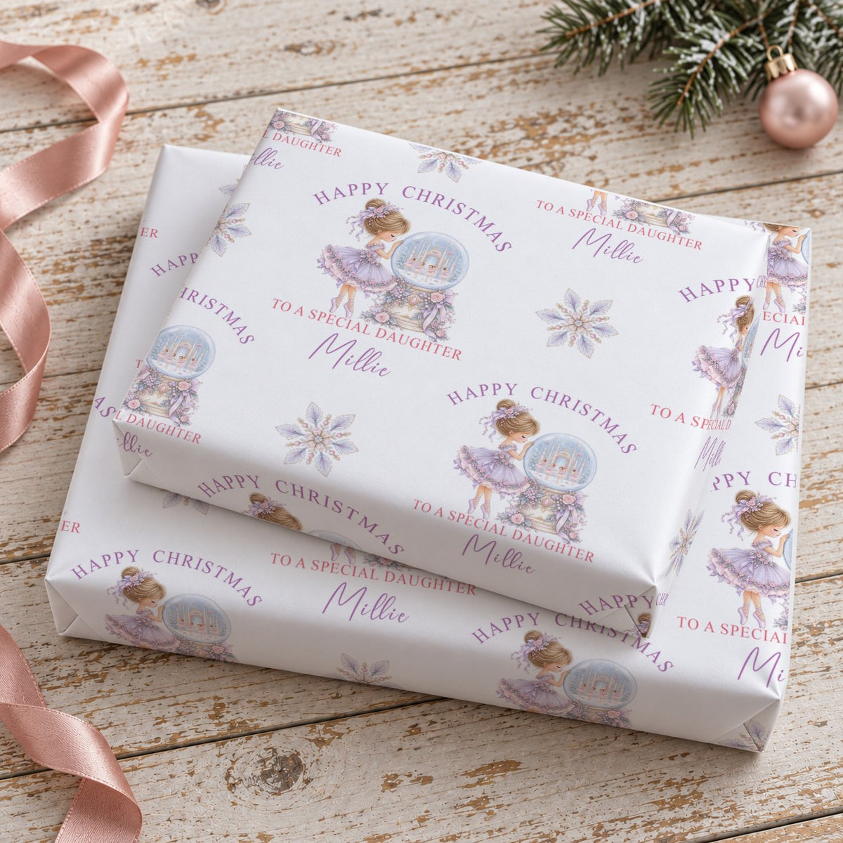 Gift wrapped in personalised ballerina Christmas wrapping paper with a lilac bow on a linen cloth