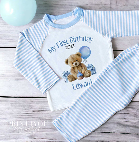 Personalised Blue Stripe Teddy Bear first birthday pyjamas, printed with a custom name on soft blue and white striped cotton.
