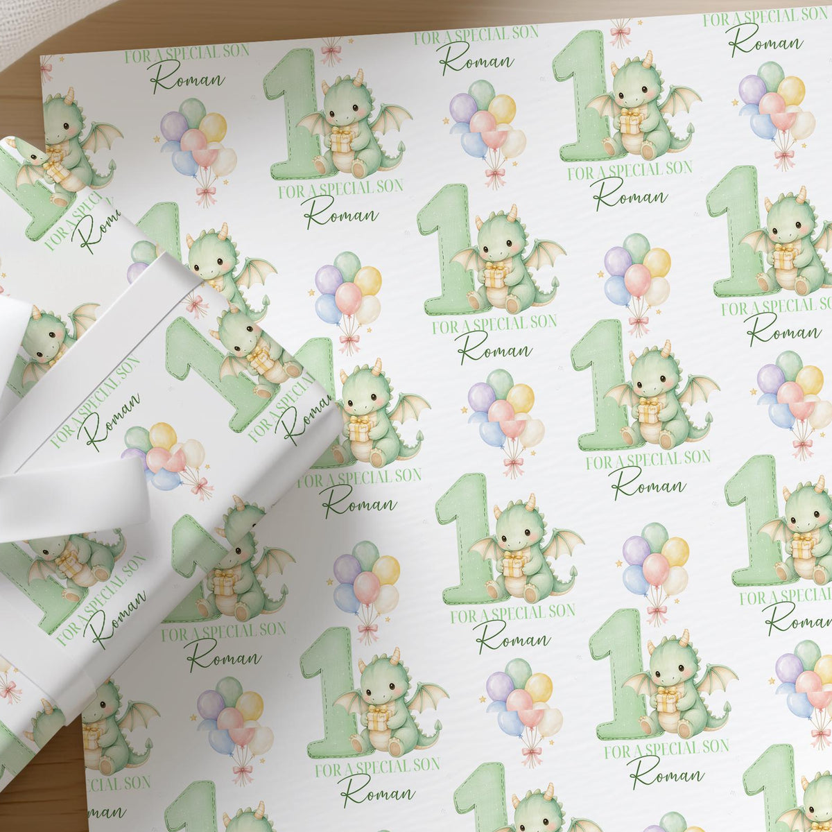 Roll of personalised dragon wrapping paper with an example name printed on the design