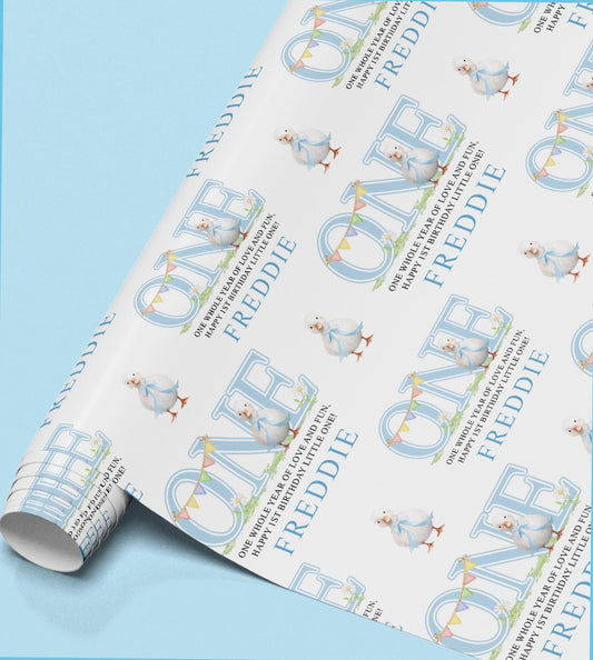 Roll of personalised wrapping paper printed with the name Freddie and a small baby bird illustration.